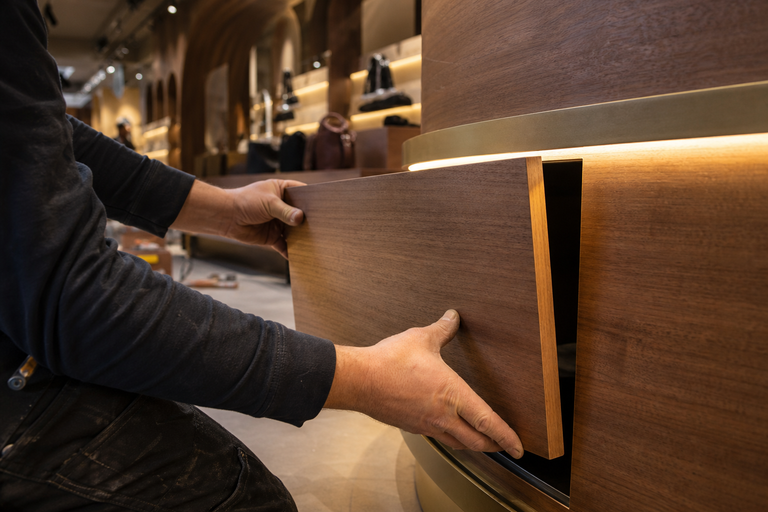 Retail store build-out with custom cabinetry and integrated lighting installed by Curated Fabrication